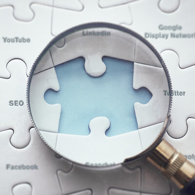 digital marketing puzzle pieces with magnifying glass in google search partners blog